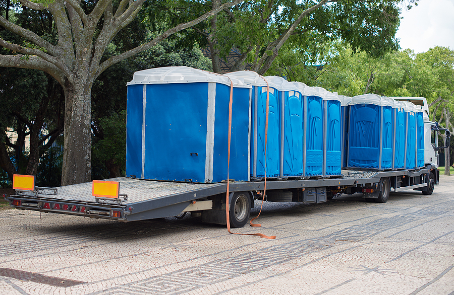 blue rental portable toilets on the truck