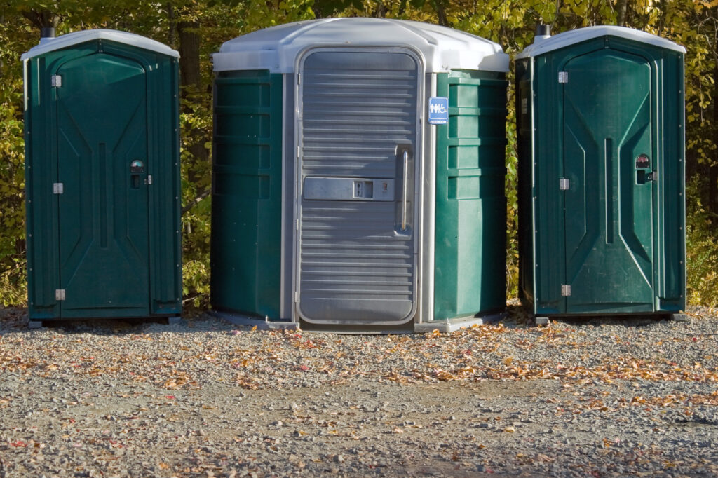 three green portable toilet
