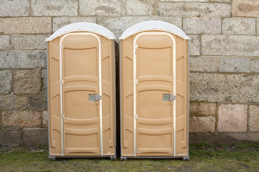 two beige portable toilets